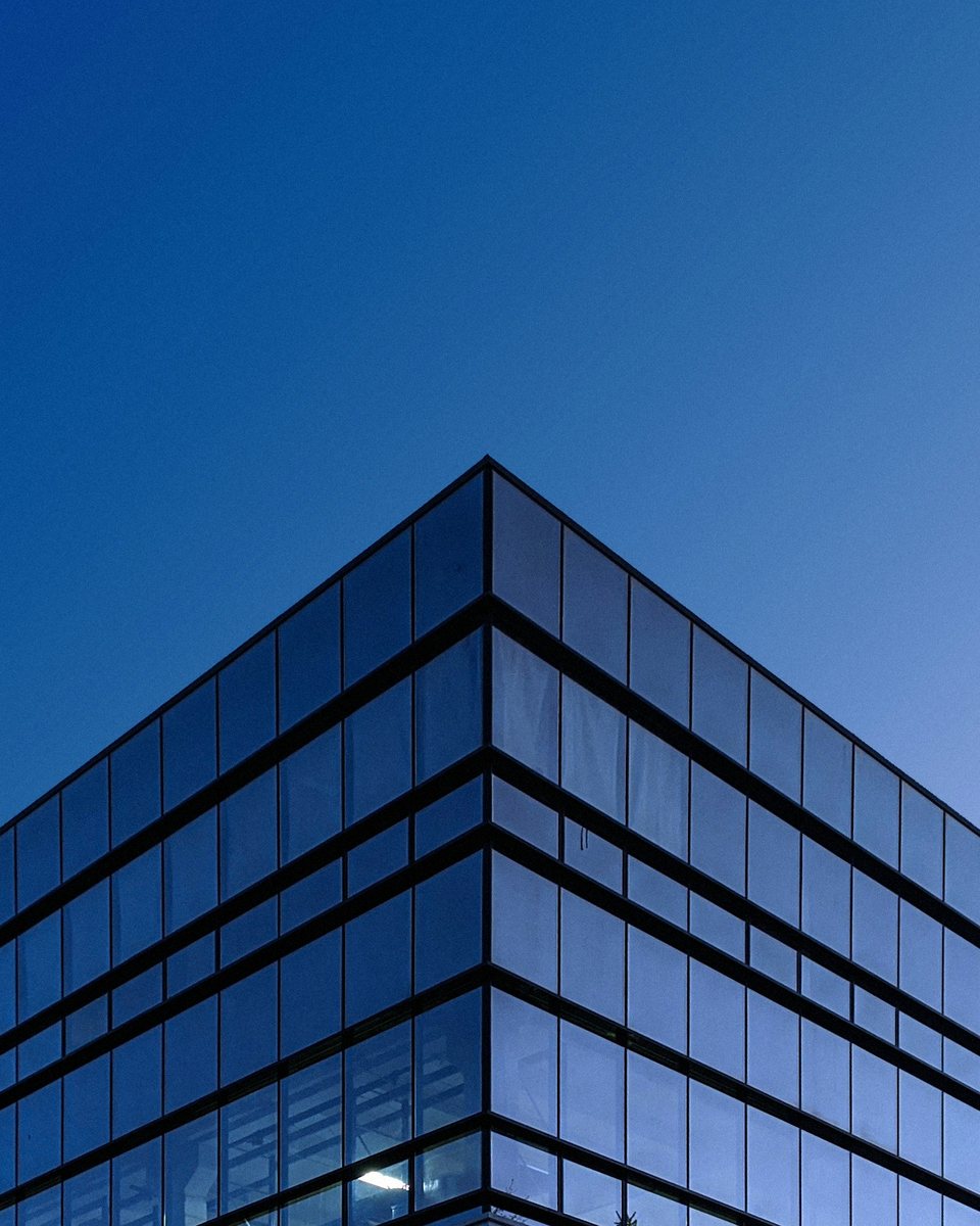 Glass office building corner at dusk