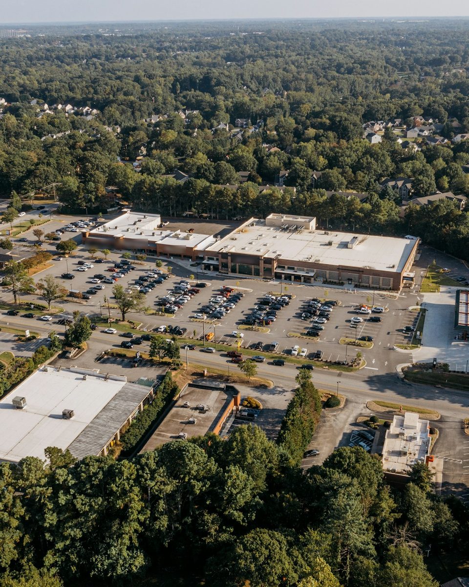 Aerial view of a shopping center and parking field